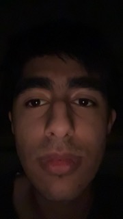 A face in a dark room